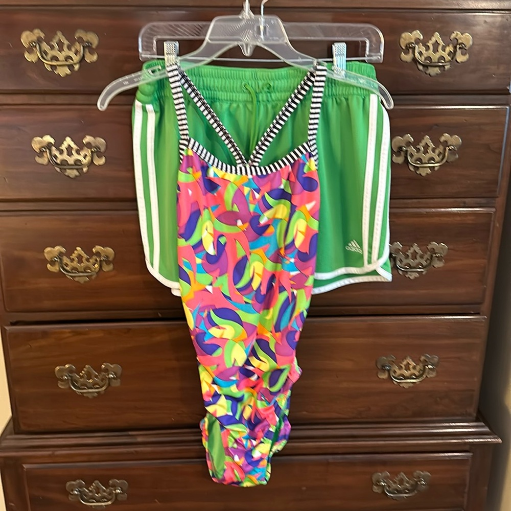 Women’s Dolfin swimsuit, matching Adidas shorts.